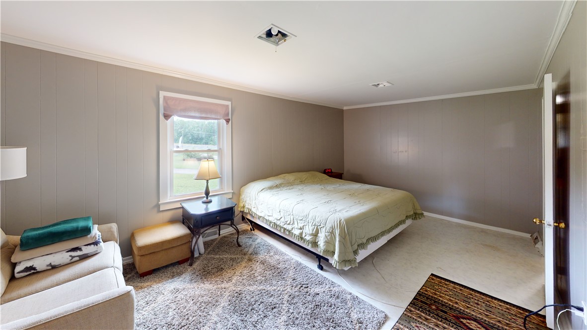 415 Church Street Pendleton, SC 29670 - Photo 4 of 35 A quiet retreat with subtle paneling and a large window offers a serene atmosphere.