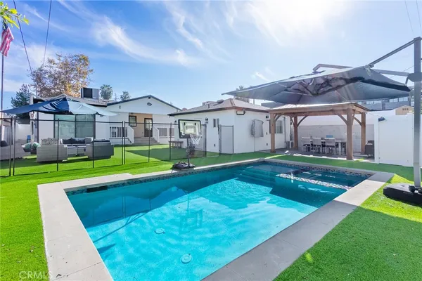 a view of an house with swimming pool garden and trees
