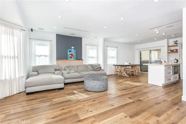 a living room with furniture and view of kitchen