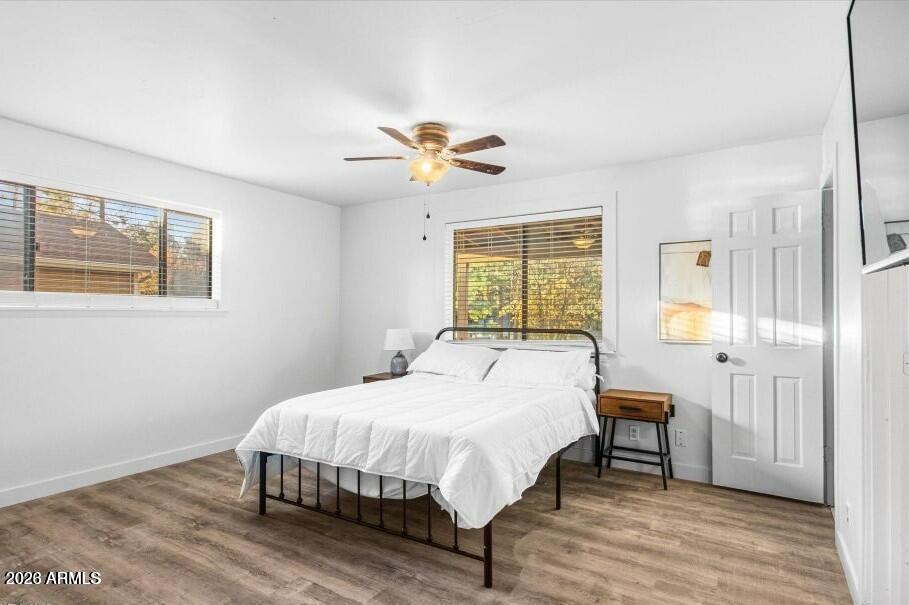 5065 Forest View Road Lakeside, AZ 85929 - Photo 12 of 24 a bedroom with a bed a chandelier and dresser