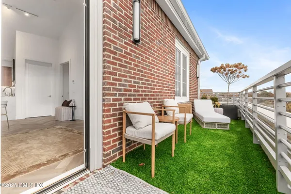 a backyard of a house with table and chairs
