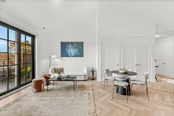 a living room with furniture and large window