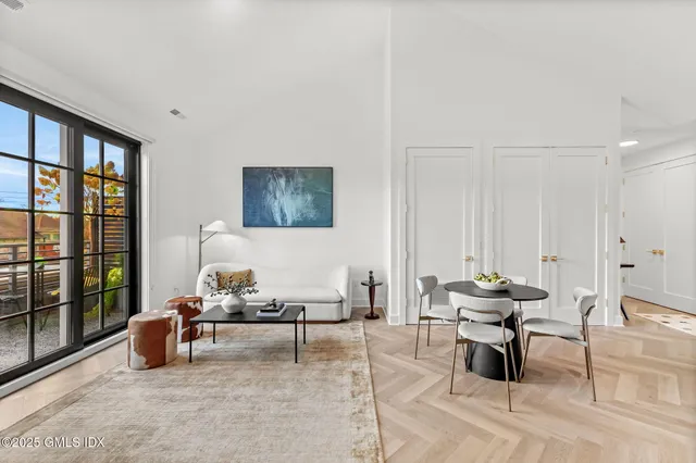 a living room with furniture and large window