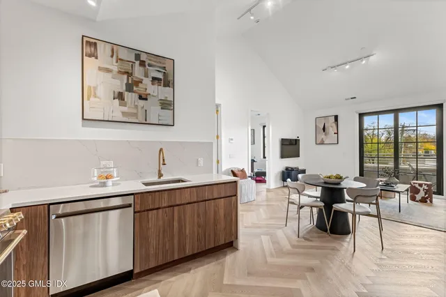 a kitchen with stainless steel appliances granite countertop a refrigerator and a stove top oven