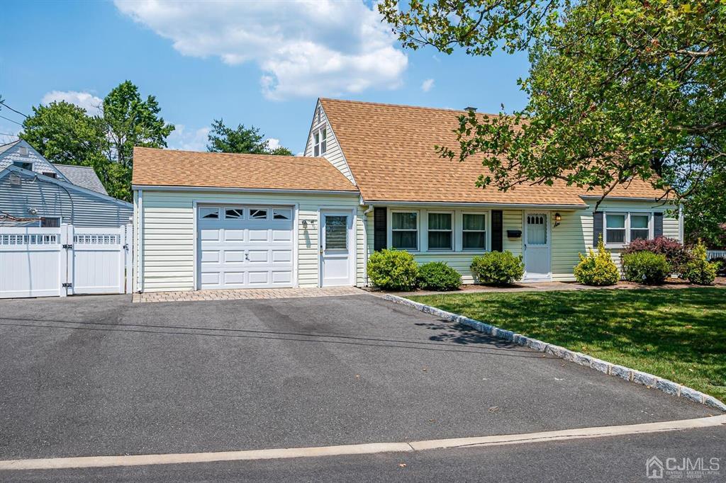 6 Frederick Avenue Colonia, NJ 07067 - Photo 2 of 33 a front view of a house with a yard and garage