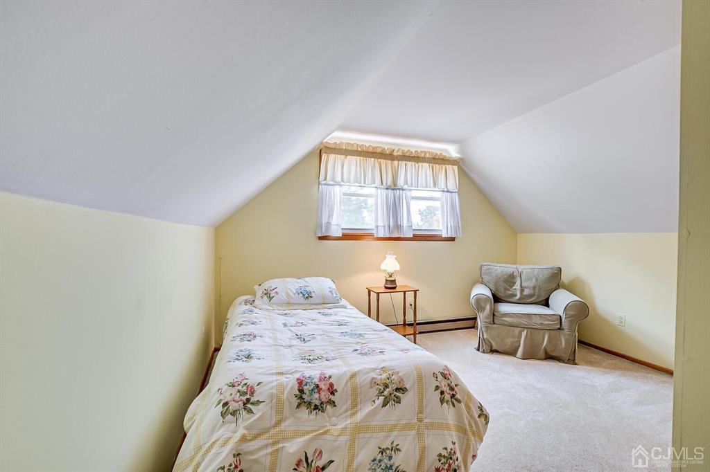 6 Frederick Avenue Colonia, NJ 07067 - Photo 26 of 33 a bedroom with a bed and chair