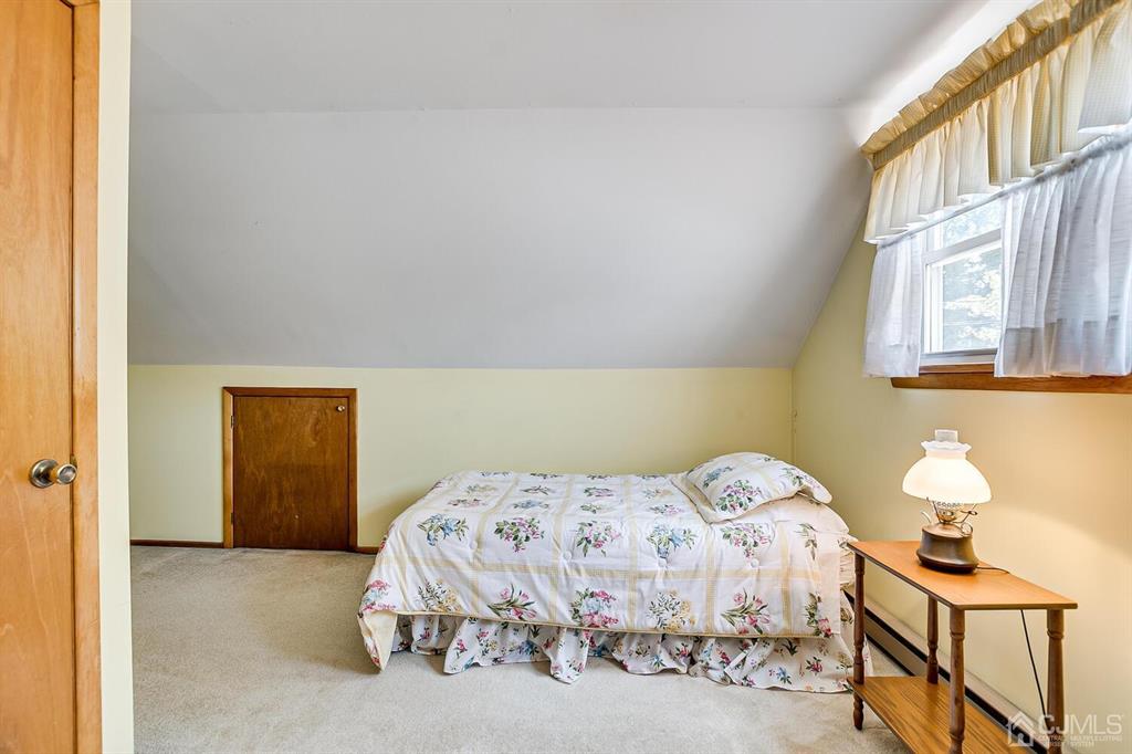 6 Frederick Avenue Colonia, NJ 07067 - Photo 27 of 33 a bedroom with a bed and painting on the wall