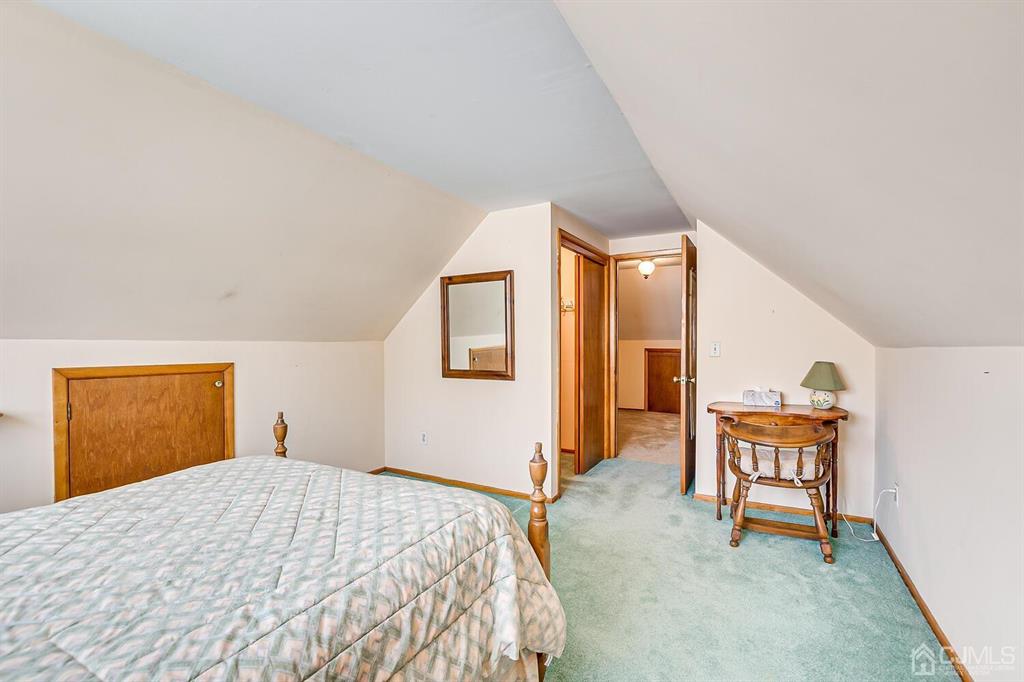 6 Frederick Avenue Colonia, NJ 07067 - Photo 29 of 33 a bedroom with a bed and a chair