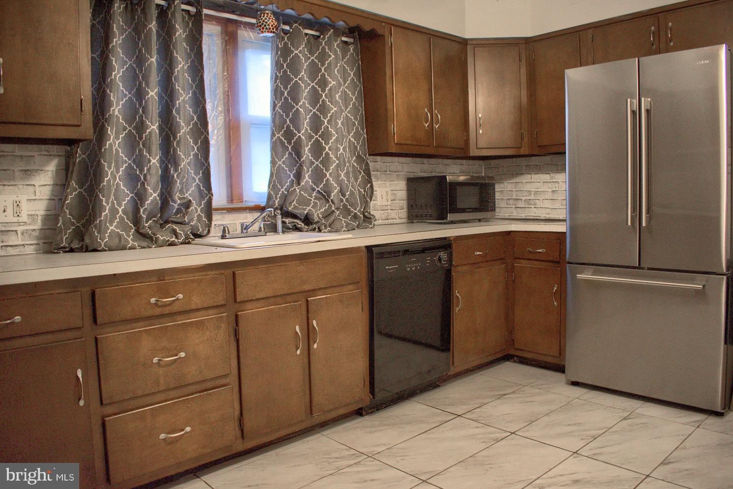 924 Hemlock Street Shamokin, PA 17872 - Photo 2 of 6 a kitchen with a refrigerator and a sink