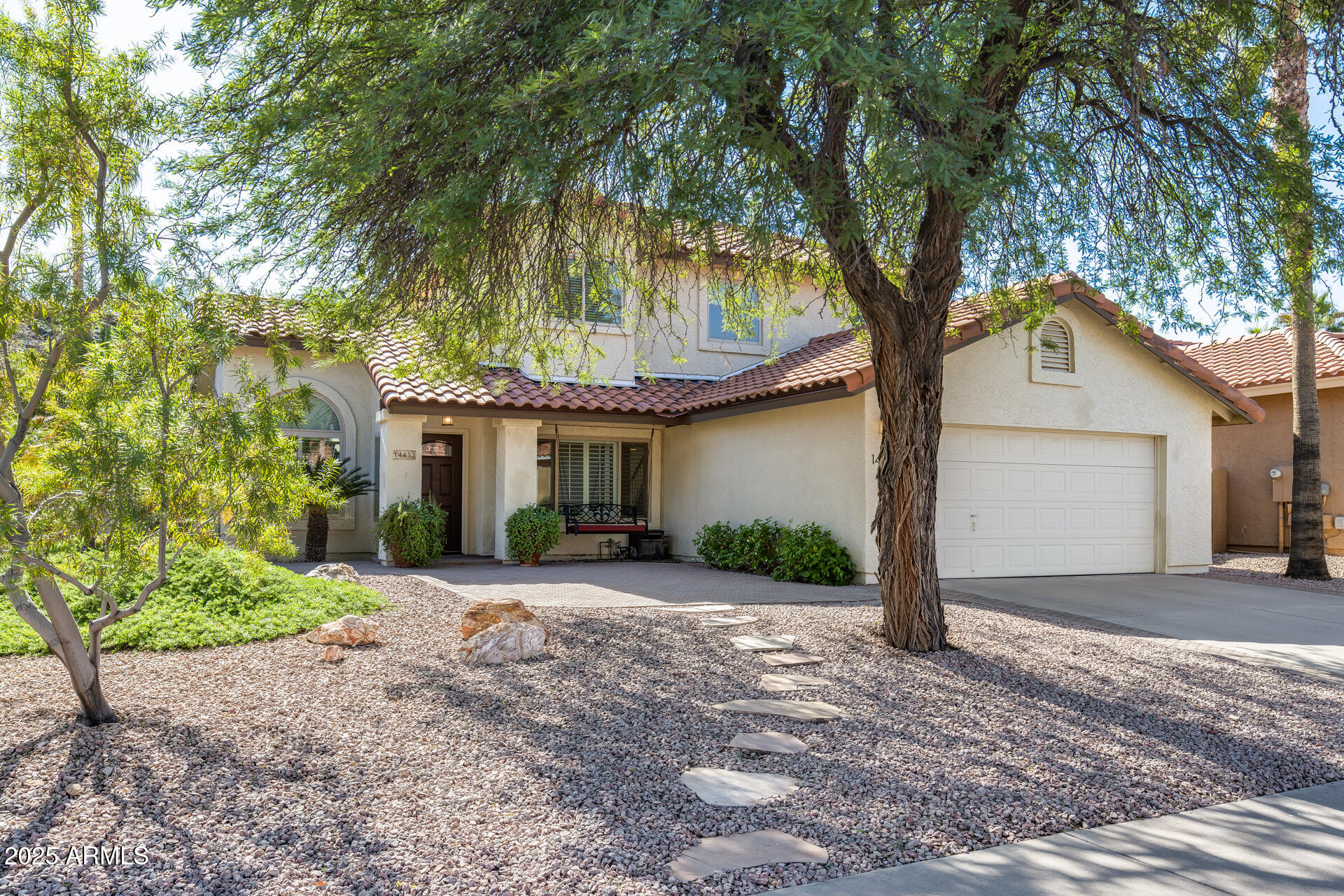 14452 South 40th Street Phoenix, AZ 85044 - Photo 11 of 92 a front view of a house with a yard and garage