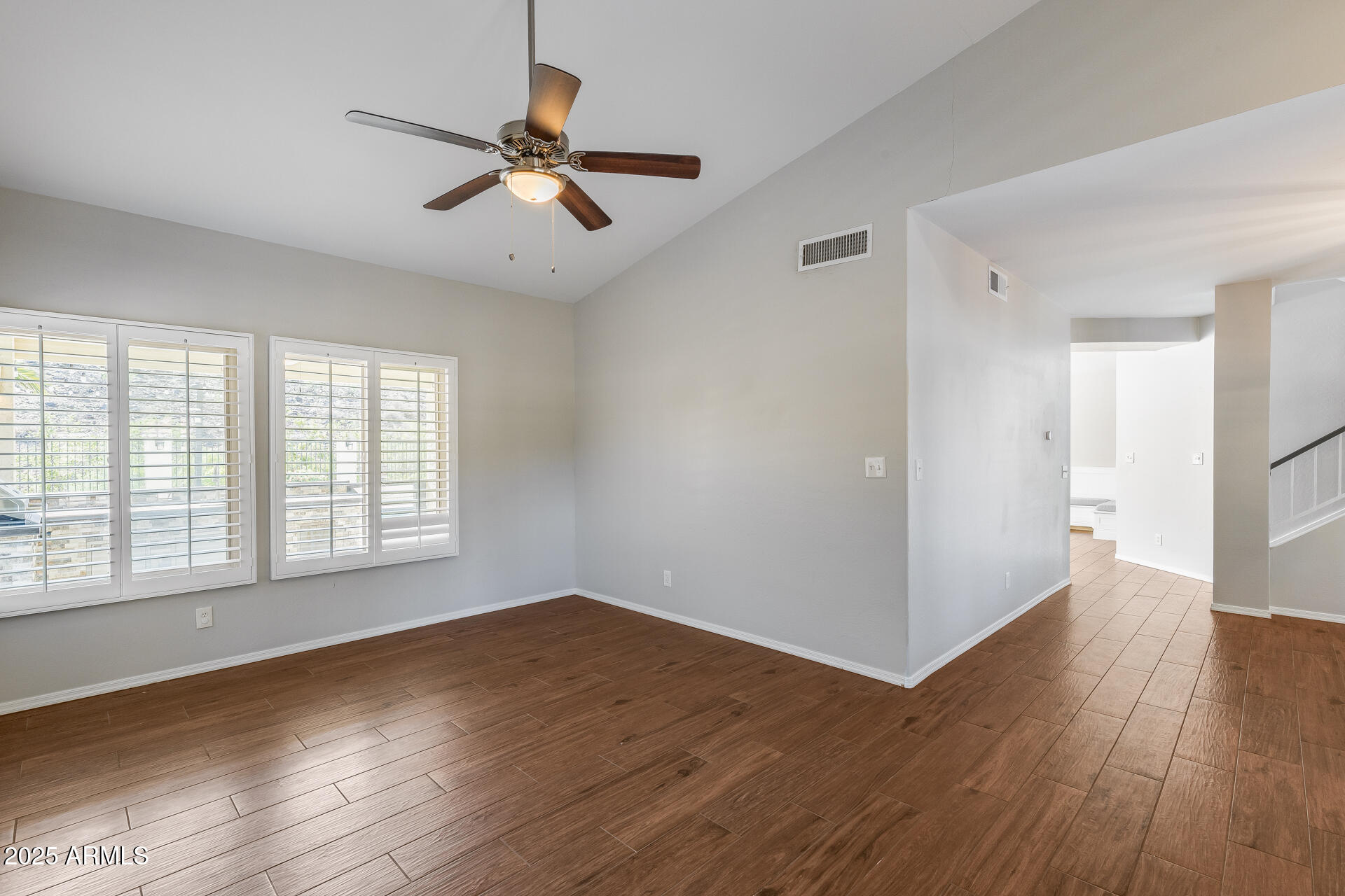 14452 South 40th Street Phoenix, AZ 85044 - Photo 19 of 92 a view of an empty room with wooden floor and a window