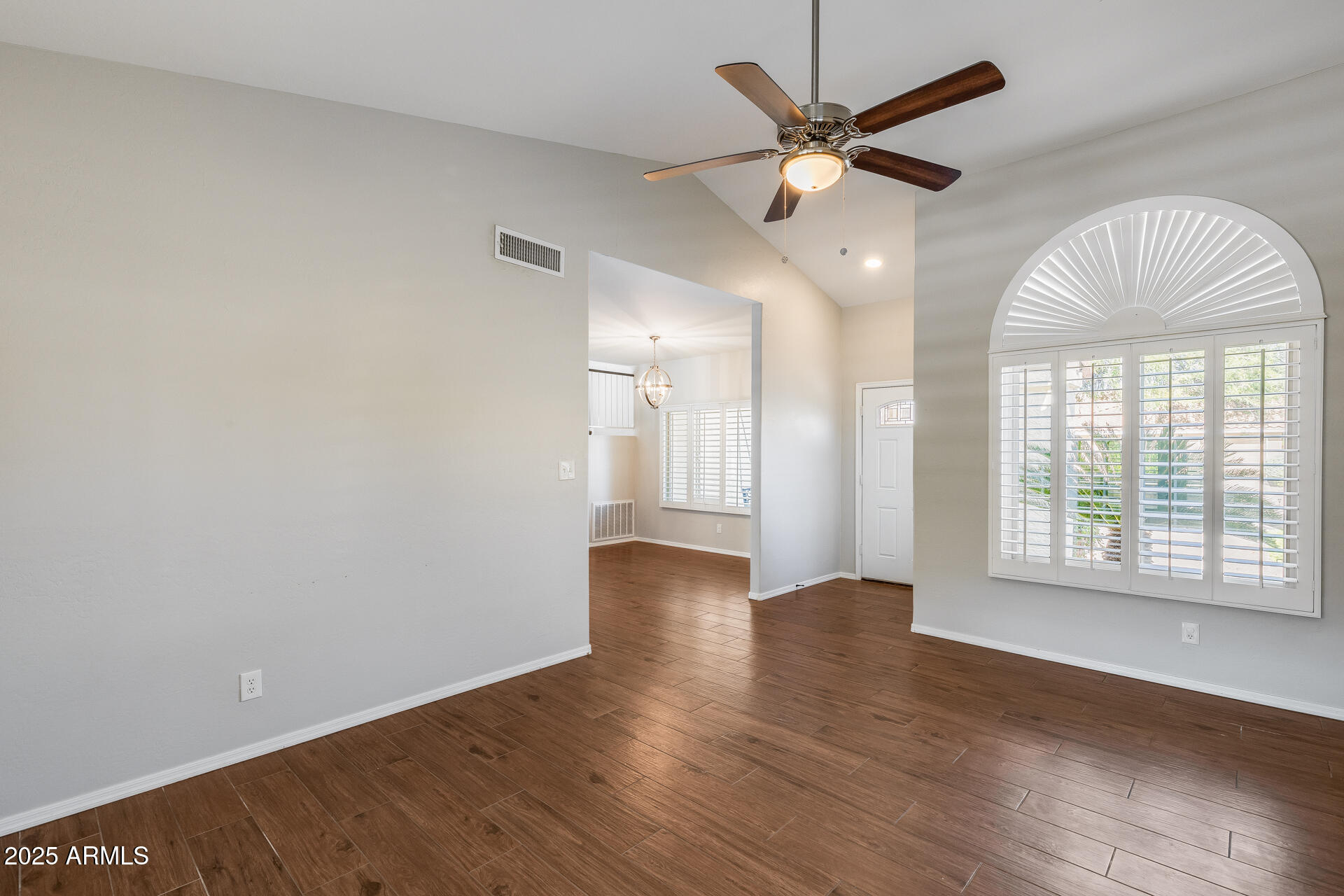 14452 South 40th Street Phoenix, AZ 85044 - Photo 20 of 92 a view of an empty room with wooden floor and a window