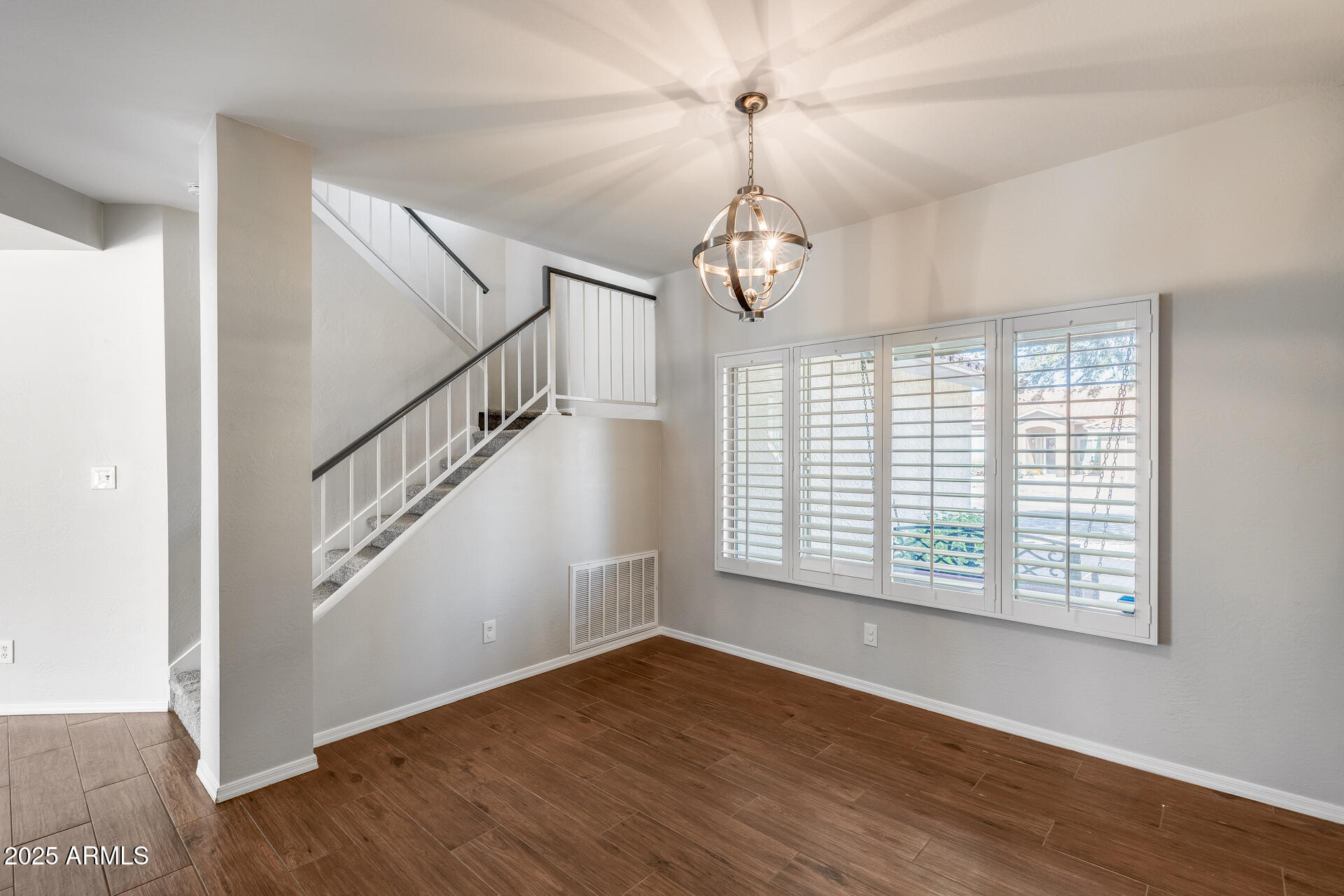 14452 South 40th Street Phoenix, AZ 85044 - Photo 21 of 92 a view of an empty room with wooden floor and a window