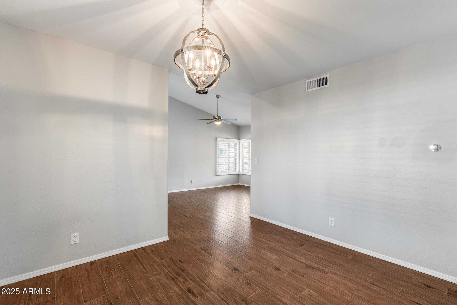 14452 South 40th Street Phoenix, AZ 85044 - Photo 23 of 92 an empty room with wooden floor and windows