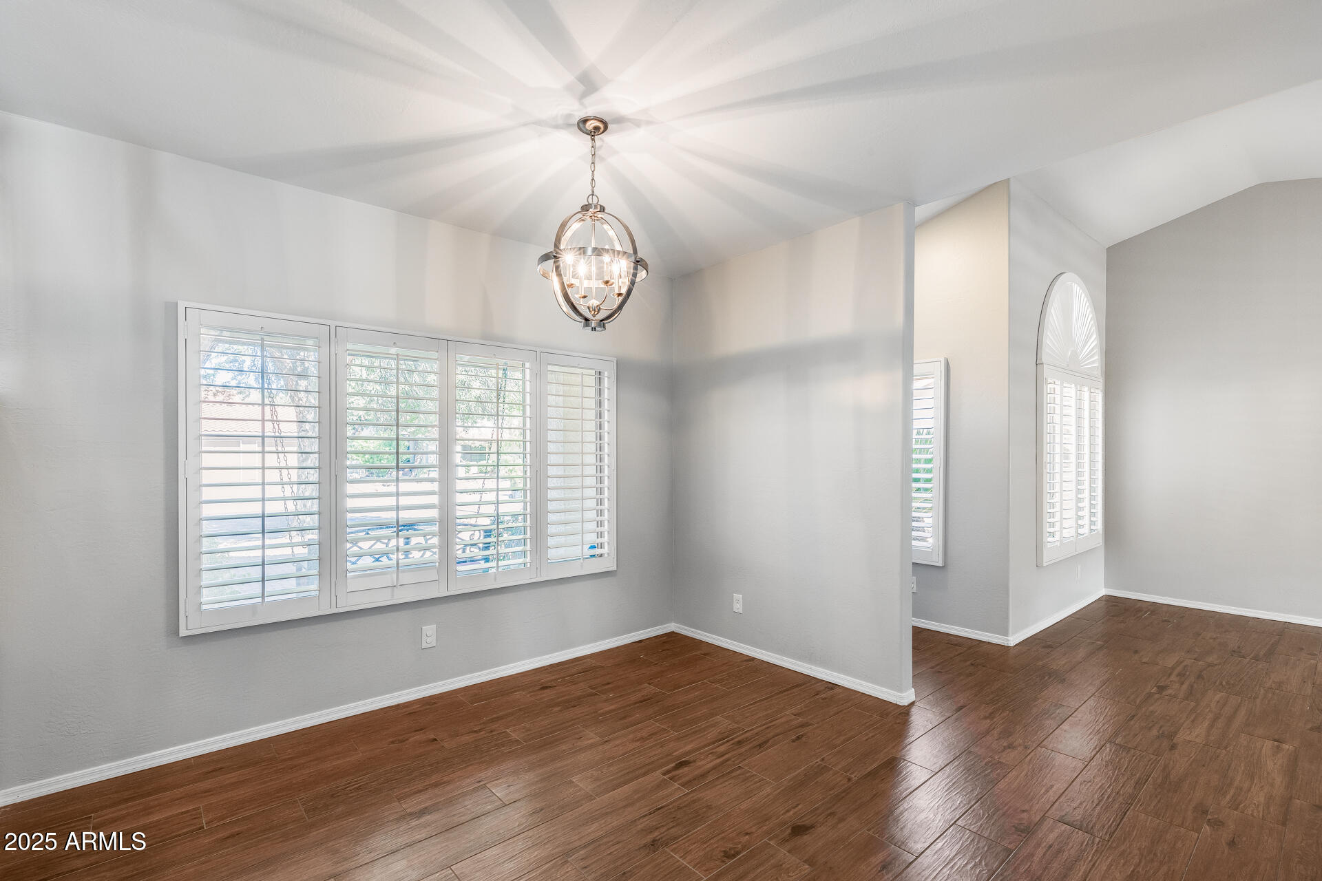 14452 South 40th Street Phoenix, AZ 85044 - Photo 24 of 92 an empty room with wooden floor fan and windows