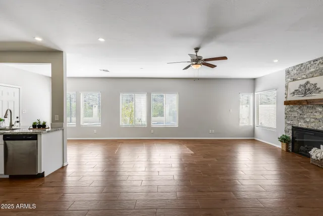 an empty room with closet and a chandelier fan