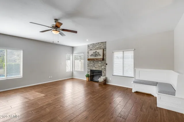 an empty room with a ceiling fan and a window