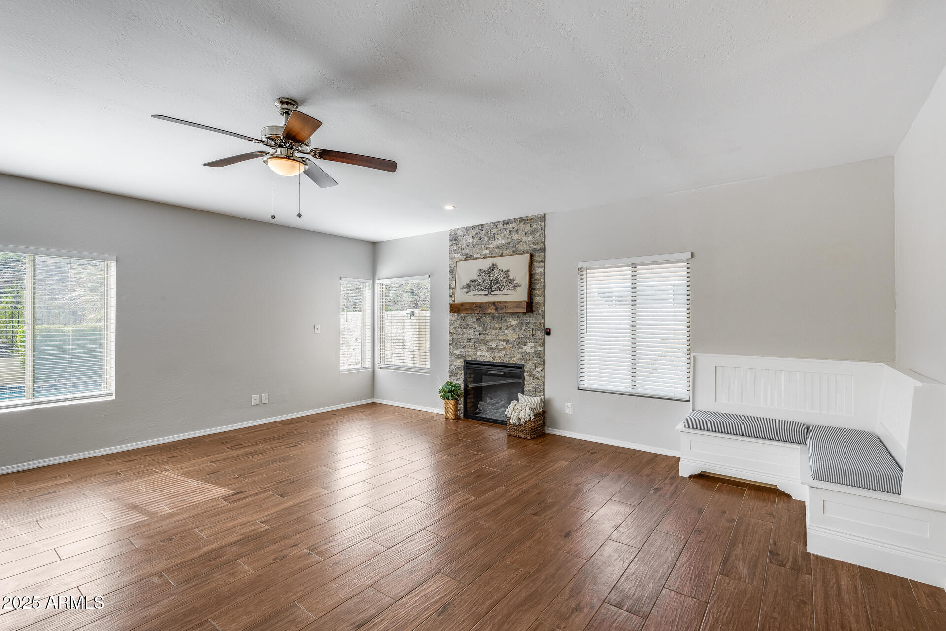 14452 South 40th Street Phoenix, AZ 85044 - Photo 26 of 92 a view of an empty room with a fireplace and wooden floor
