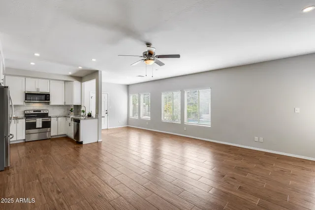 a spacious bedroom with a bed and a couch