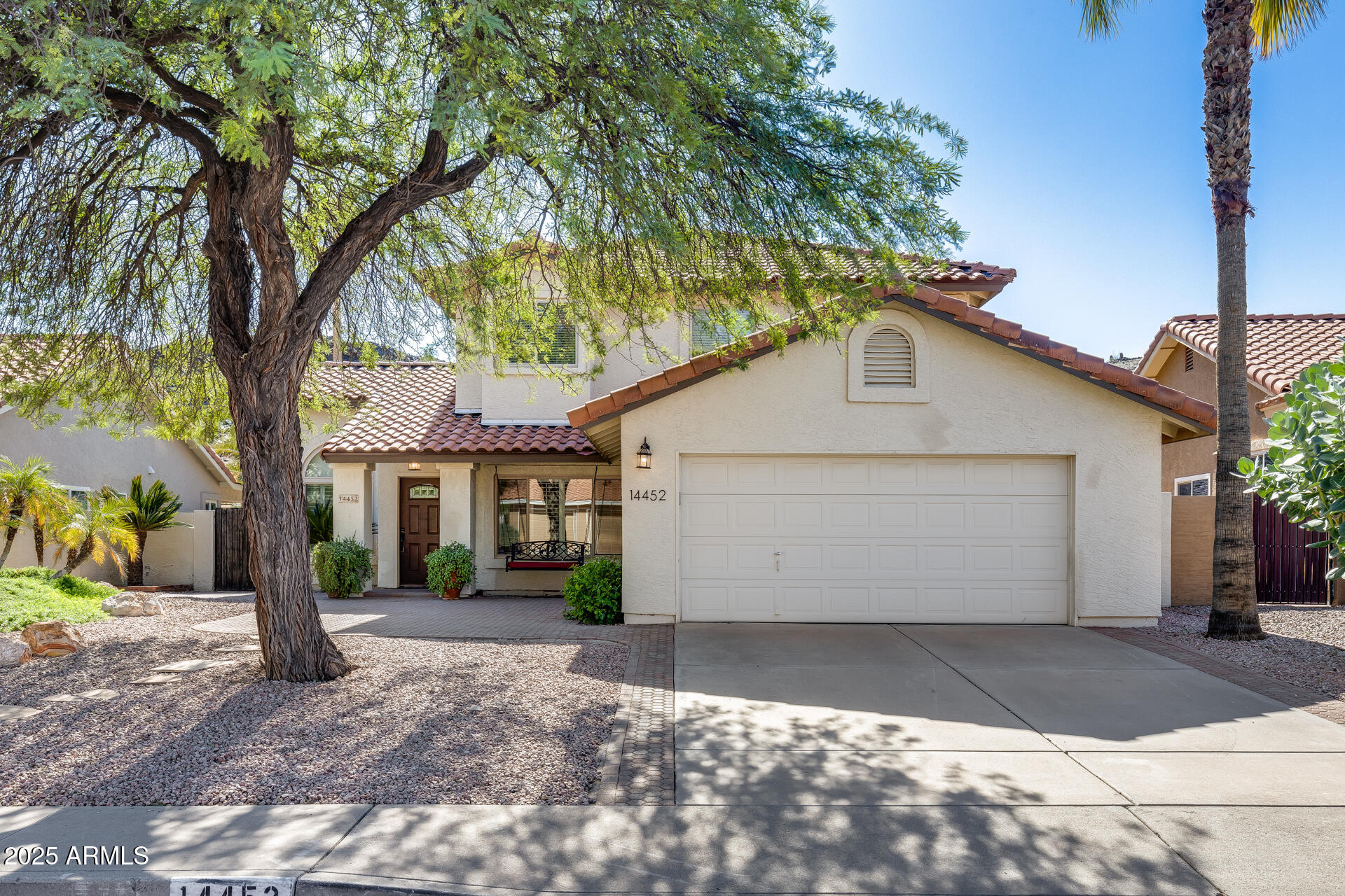 14452 South 40th Street Phoenix, AZ 85044 - Photo 2 of 92 a front view of a house with a yard and potted plants