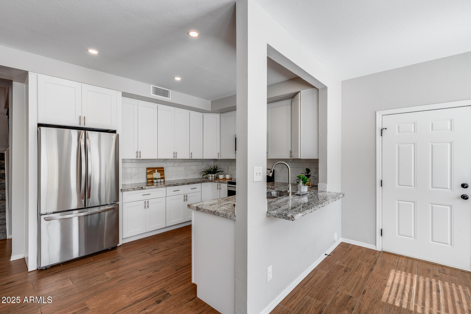 14452 South 40th Street Phoenix, AZ 85044 - Photo 33 of 92 a kitchen with white cabinets and stainless steel appliances