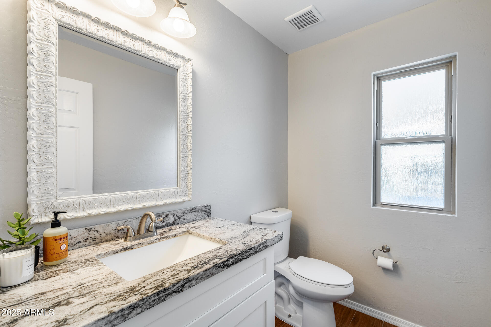 14452 South 40th Street Phoenix, AZ 85044 - Photo 39 of 92 a bathroom with a granite countertop sink a toilet and a mirror