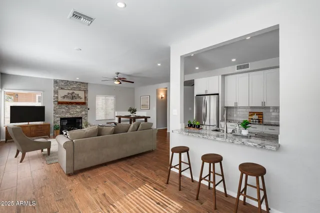 a living room with fireplace furniture and a wooden floor