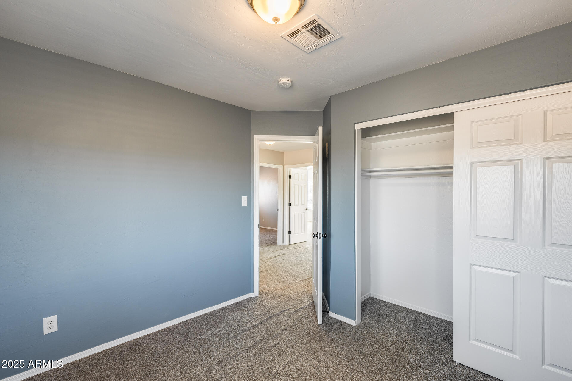 14452 South 40th Street Phoenix, AZ 85044 - Photo 45 of 92 an empty room with closet and a chandelier fan