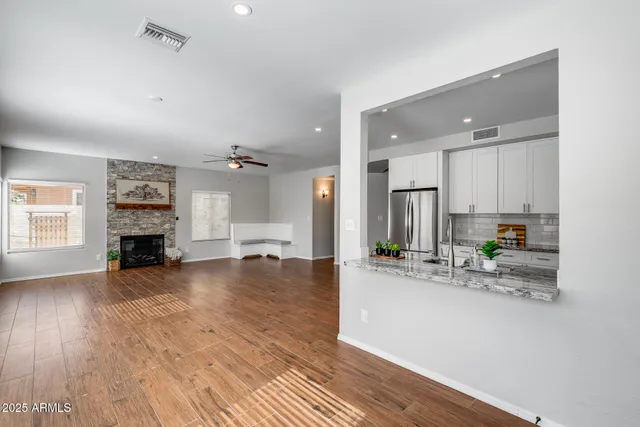 a kitchen with granite countertop white cabinets sink and stainless steel appliances