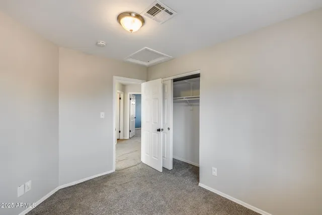 a living room with couch and a ceiling fan