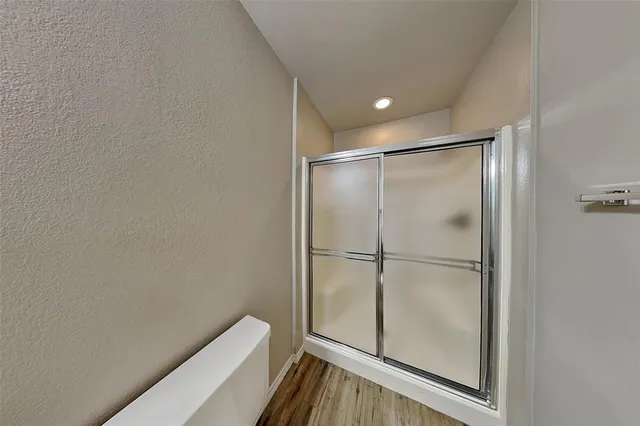 a bathroom with a glass shower door