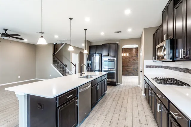 a view of kitchen with cabinets and refrigerator