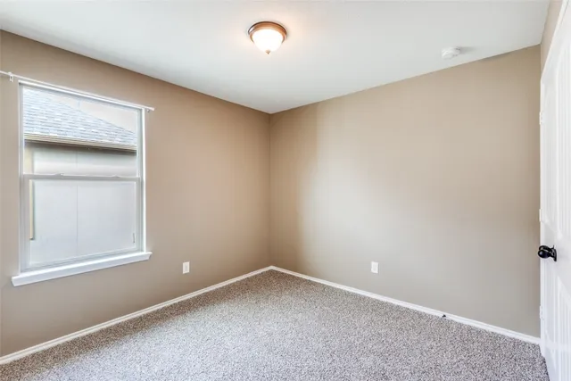 a view of a hallway with windows and stairs