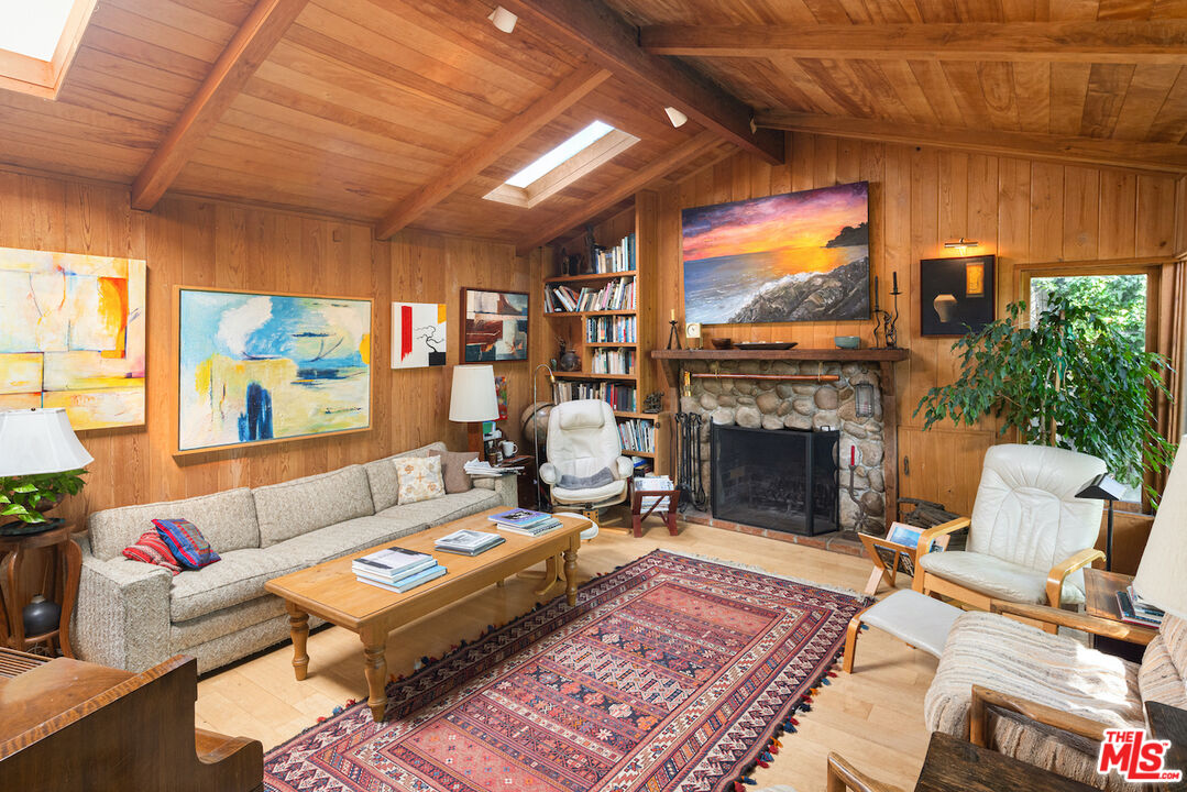 537 West Rustic Road Santa Monica, CA 90402 - Photo 2 of 22 a living room with furniture a fireplace and a flat screen tv