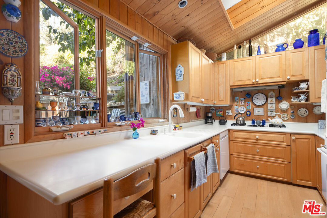 537 West Rustic Road Santa Monica, CA 90402 - Photo 6 of 22 a kitchen with stainless steel appliances a sink and cabinets