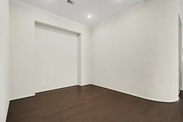 an empty room with wooden floor
