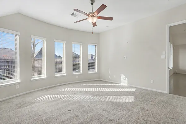 a view of a livingroom with a window and a ceiling fan