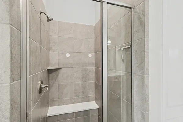 a bathroom with a glass shower door