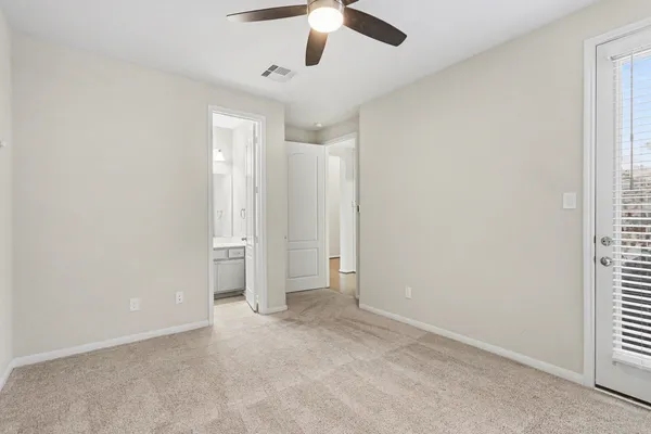 an empty room with chandelier fan