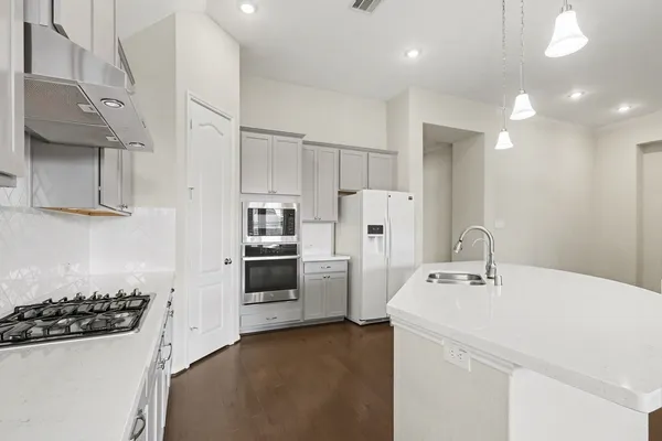 a kitchen with a sink a stove and refrigerator