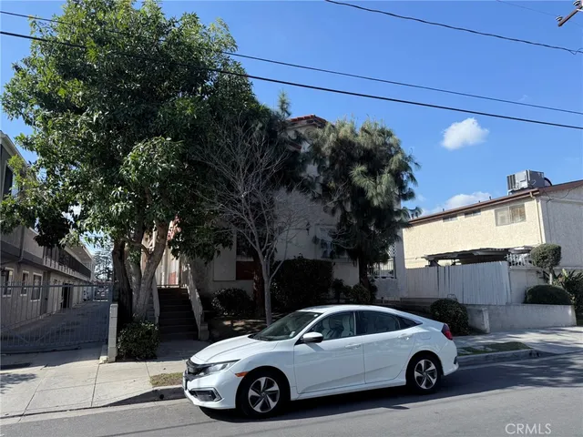 a view of a car parked in front of a house