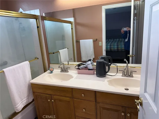 a bathroom with a double vanity sink and a mirror