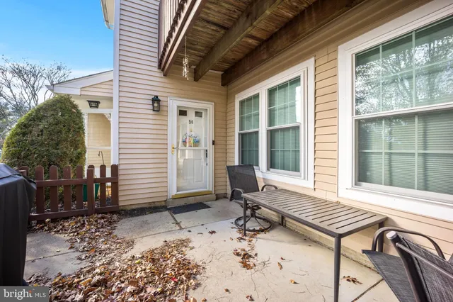a view of a patio with table and chairs and potted plants