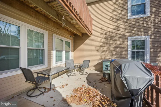 a front view of a house with a yard and tree s