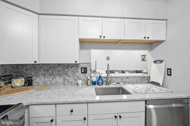a kitchen with stainless steel appliances granite countertop a sink and cabinets
