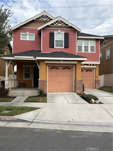 a front view of a house with garage and parking