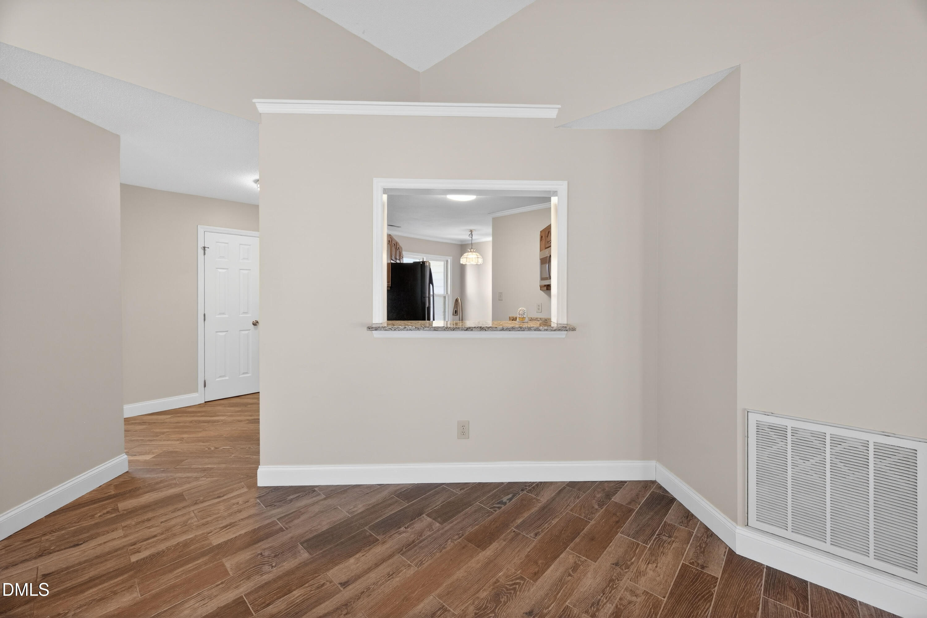 109 Linville River Road Cary, NC 27511 - Photo 13 of 41 a view of an empty room with wooden floor and a window