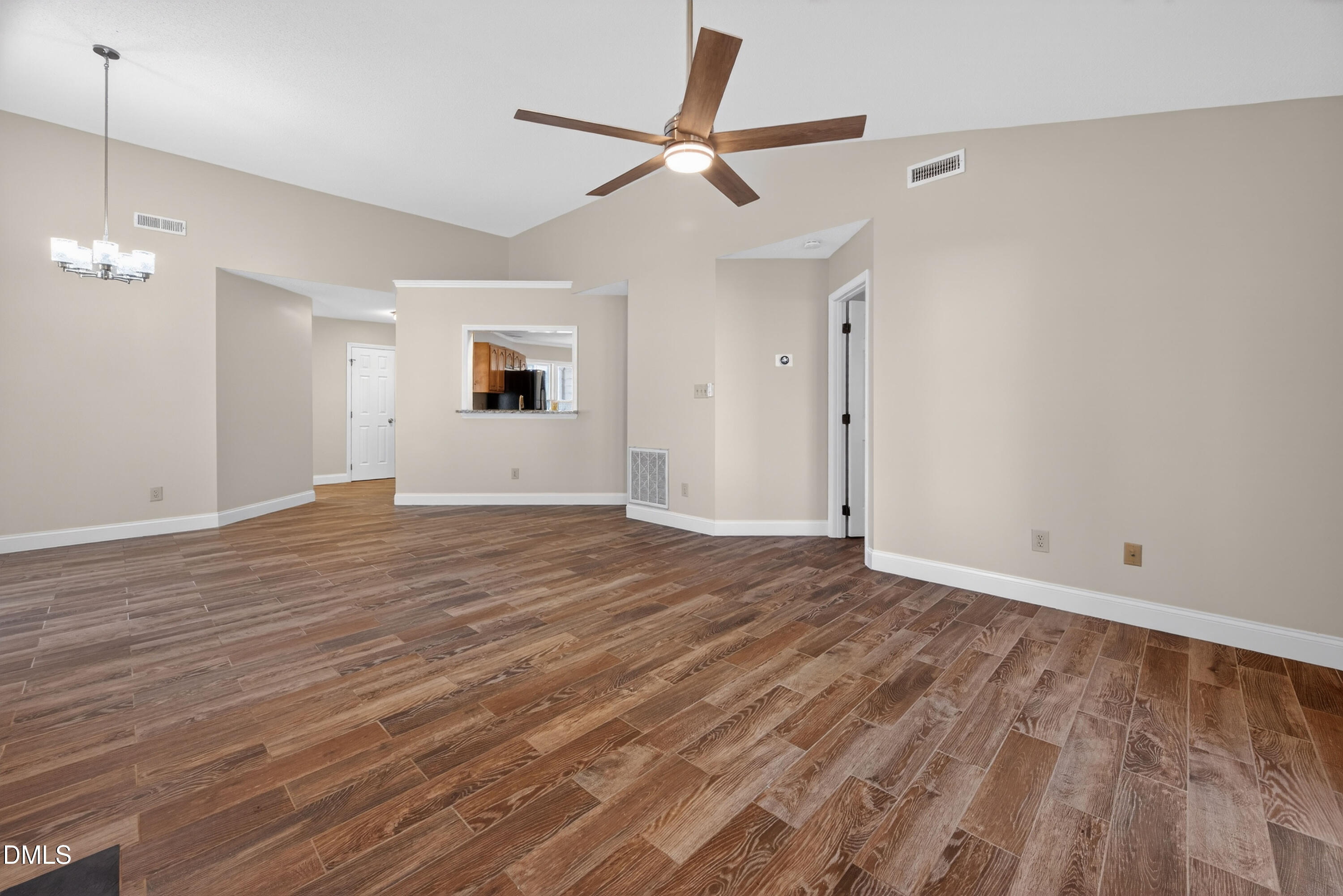 109 Linville River Road Cary, NC 27511 - Photo 14 of 41 a view of an empty room with wooden floor and a ceiling fan