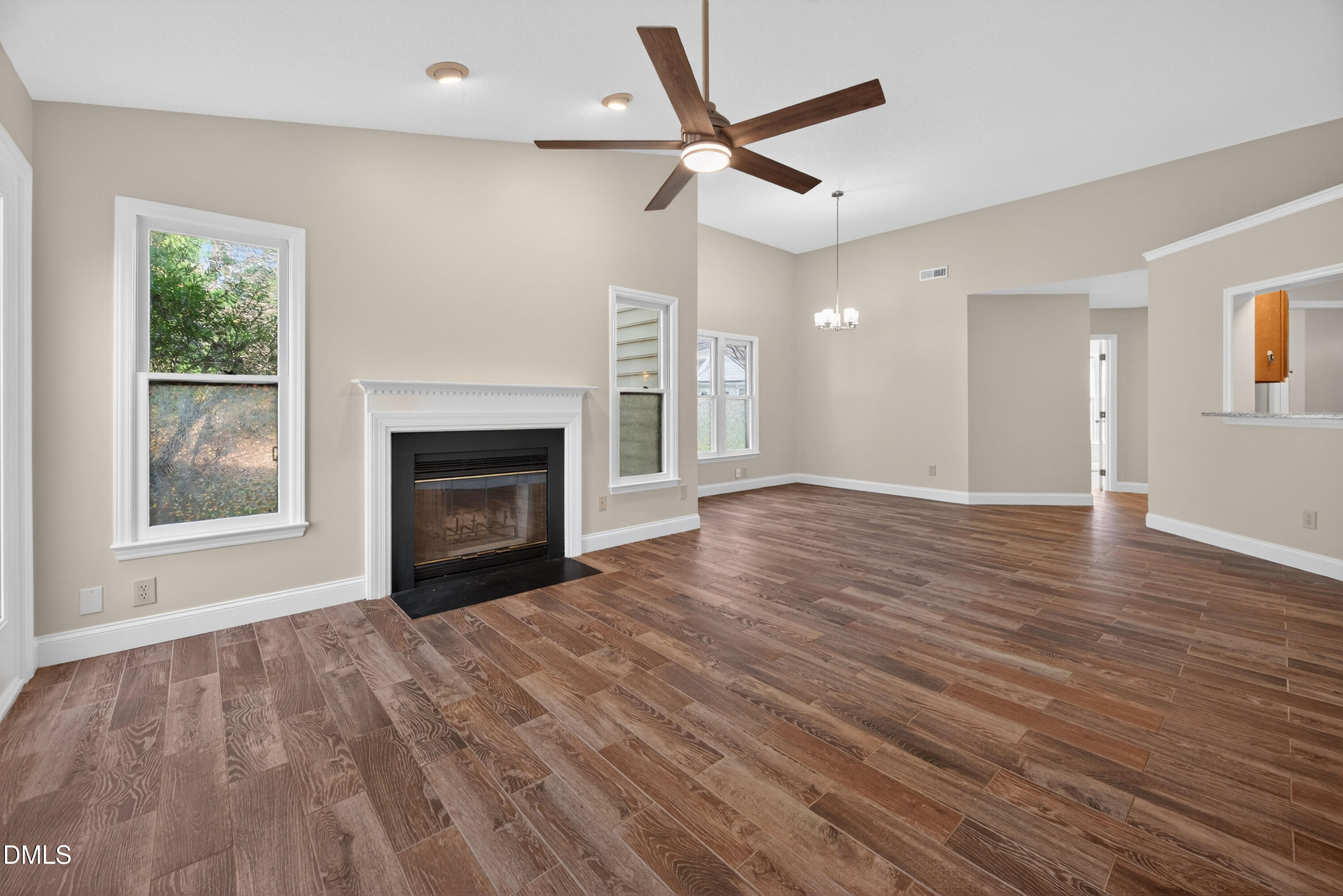 109 Linville River Road Cary, NC 27511 - Photo 18 of 41 a view of empty room with wooden floor and fireplace