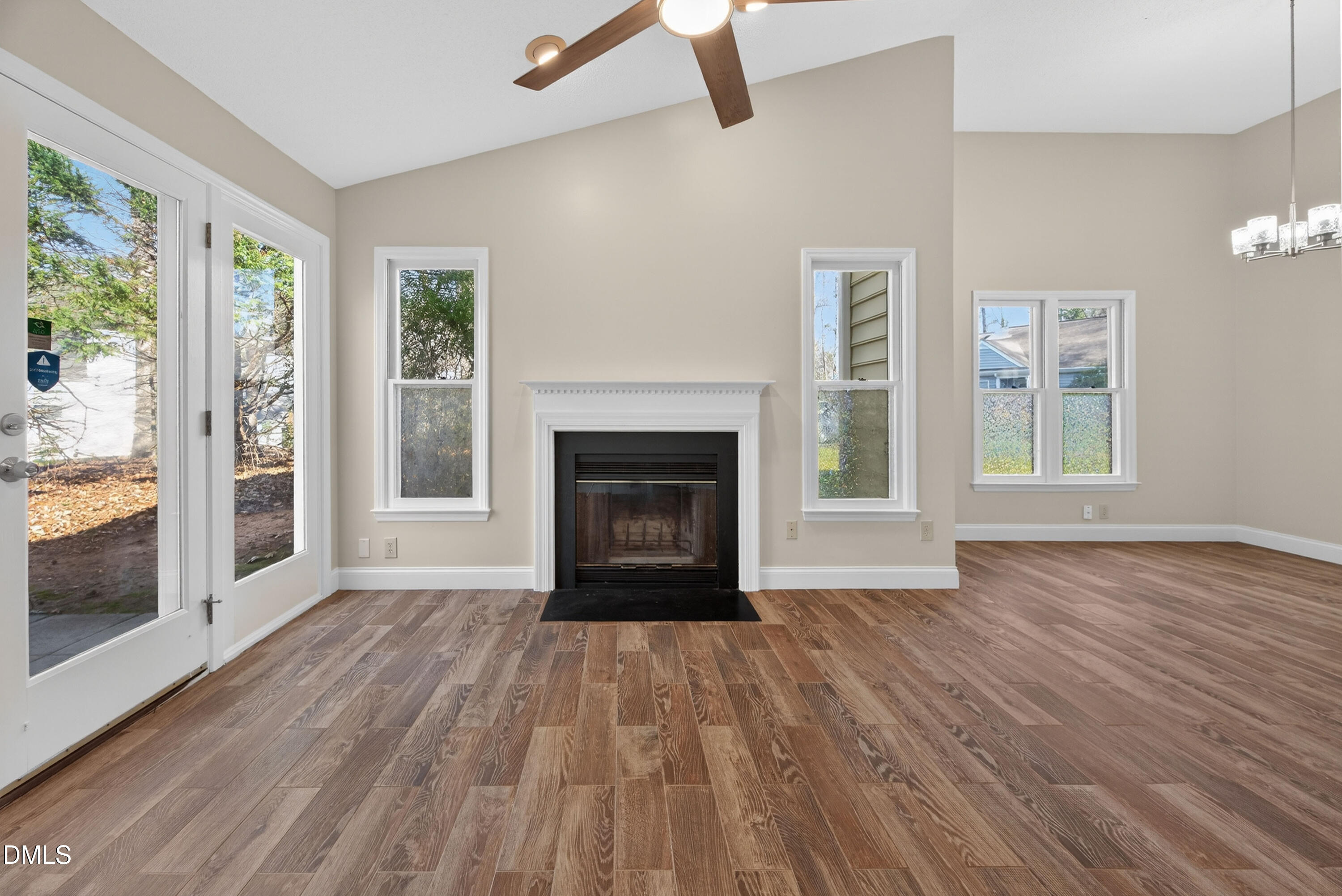 109 Linville River Road Cary, NC 27511 - Photo 19 of 41 a view of an empty room with wooden floor fireplace and a window